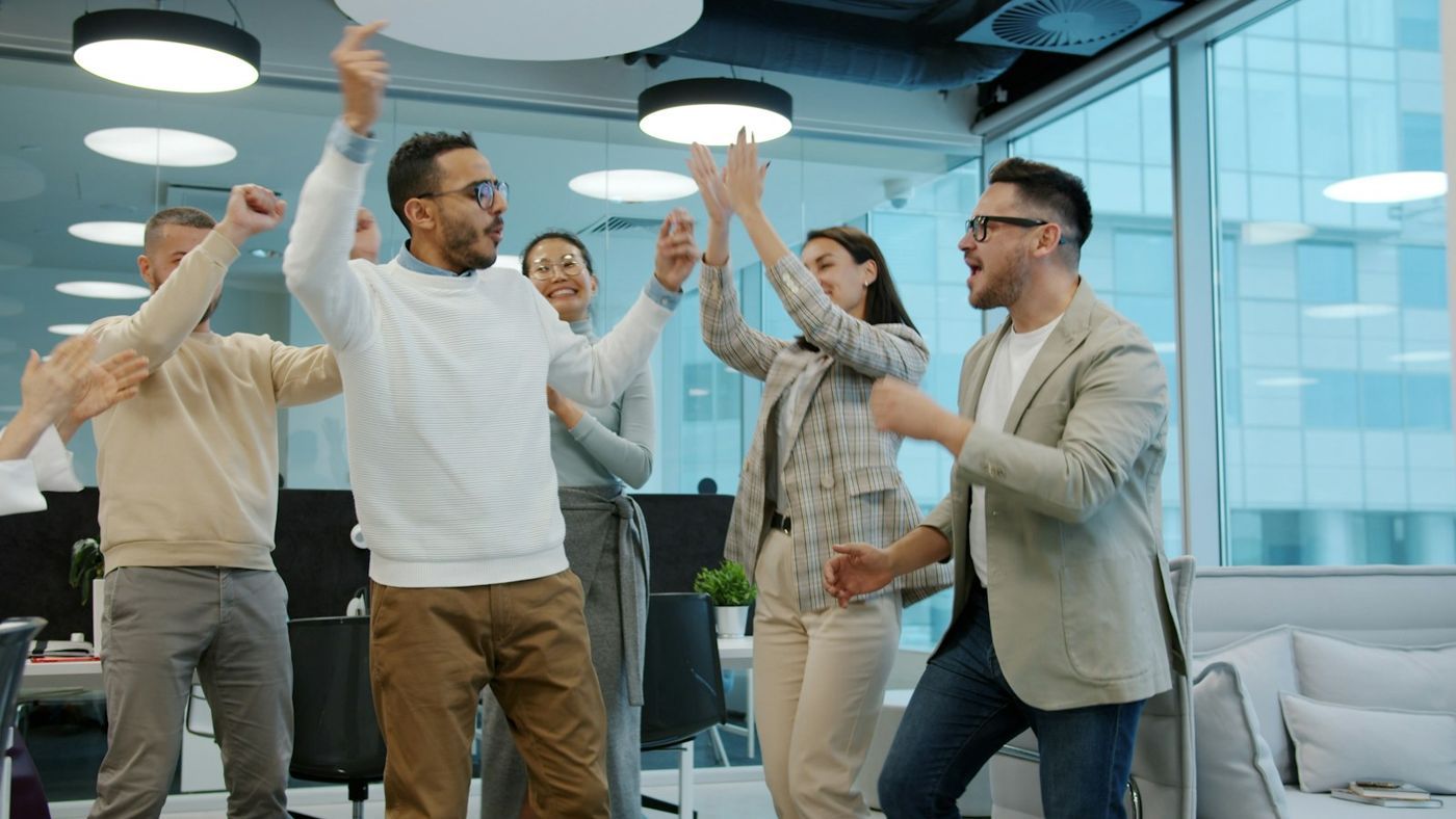 A team celebrating a success in the office